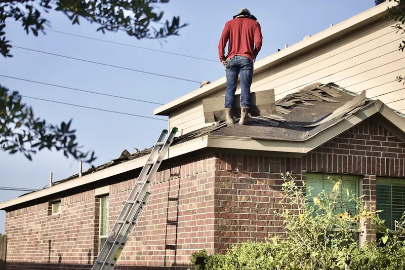 Professional roofer working on a residential roof in Little River-Academy